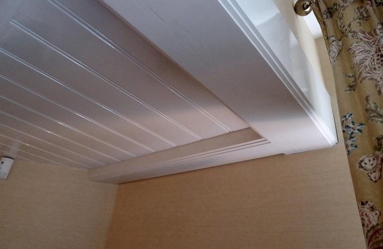 Grenen lambrisering op plafond.